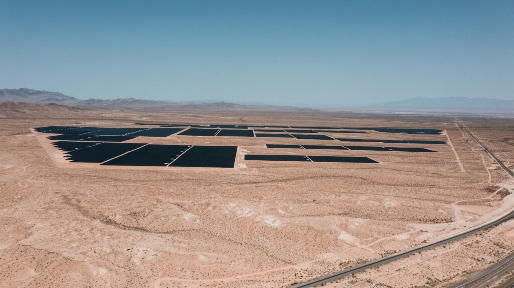 A panoramic view of solar panels in a Nevada desert landscape, showcasing solar energy solutions. — renewable energy sol…