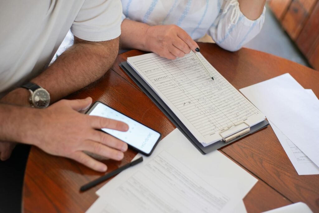 A photo of a family reviewing their energy bills alongside an energy efficiency consultant. — energy efficiency programs…