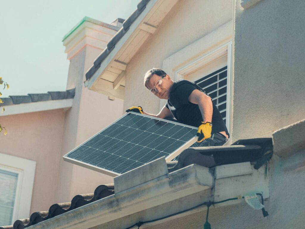 Workers installing solar panels on a residential roof. — Nevada clean energy jobs