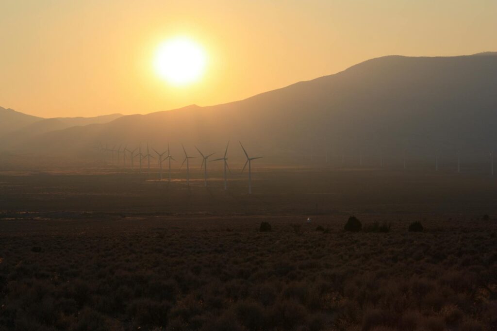 a picture of a wind turbine field in Nevada against a scenic backdrop — Nevada clean energy programs