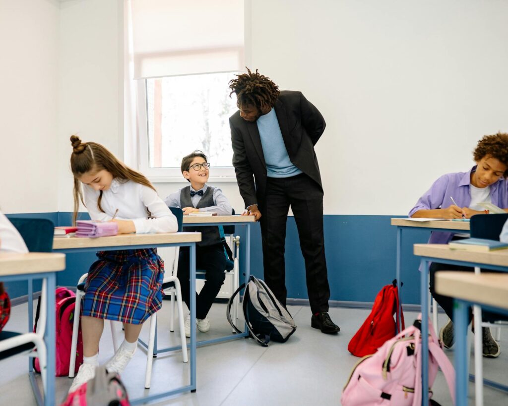 A classroom setting with engaged students and a supportive teacher, symbolizing effective education. — Paul For Nevada e…