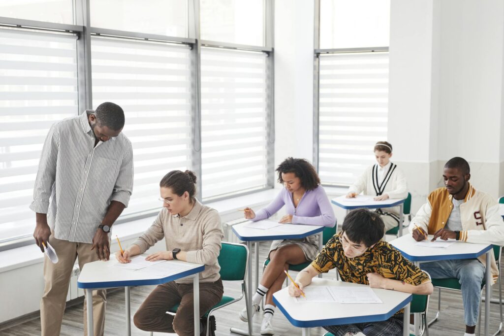 A diverse group of teachers collaborating on curriculum development, highlighting the importance of teacher support. — P…