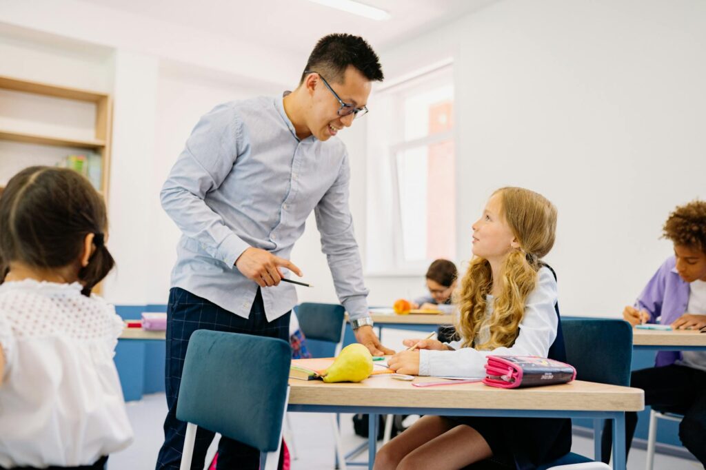 A photo of a teacher engaging with students in a modern classroom — Paul For Nevada education policy