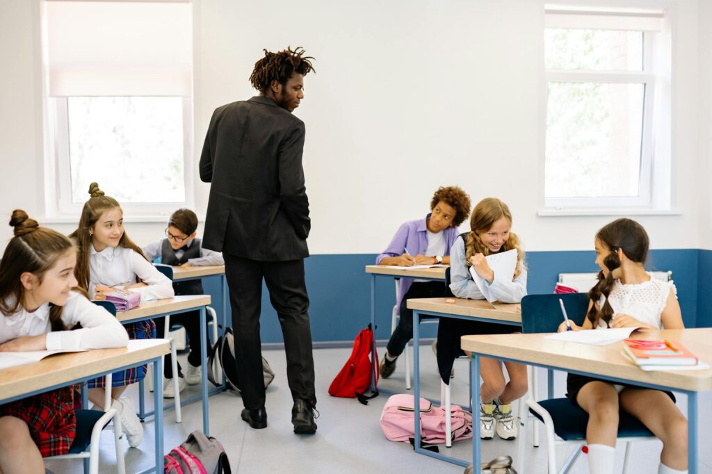Image showing Paul interacting with students in a classroom setting, emphasizing Paul For Nevada education reform