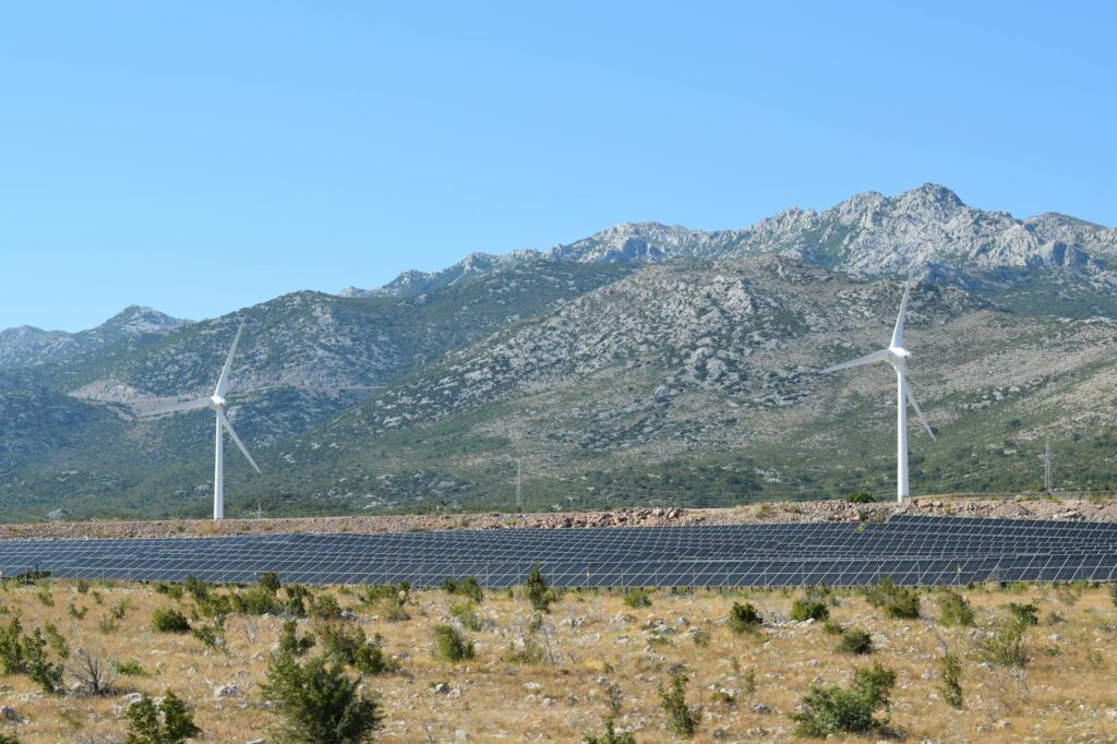 Images of solar panels and wind turbines in Nevada's landscape. — Paul For Nevada renewable energy