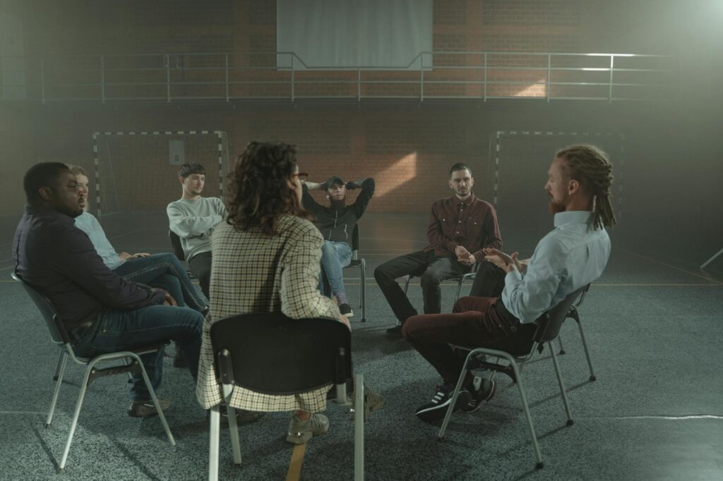 Photo of a community meeting discussing mental health support initiatives. This image illustrates the engagement in the Paul For Nevada healthcare policy regarding mental health support.