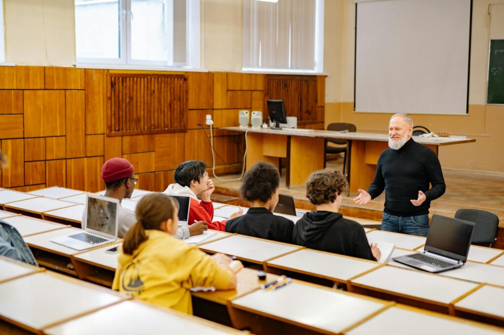 A classroom scene showing engaged students and teachers using technology in the Paul For Nevada education plan