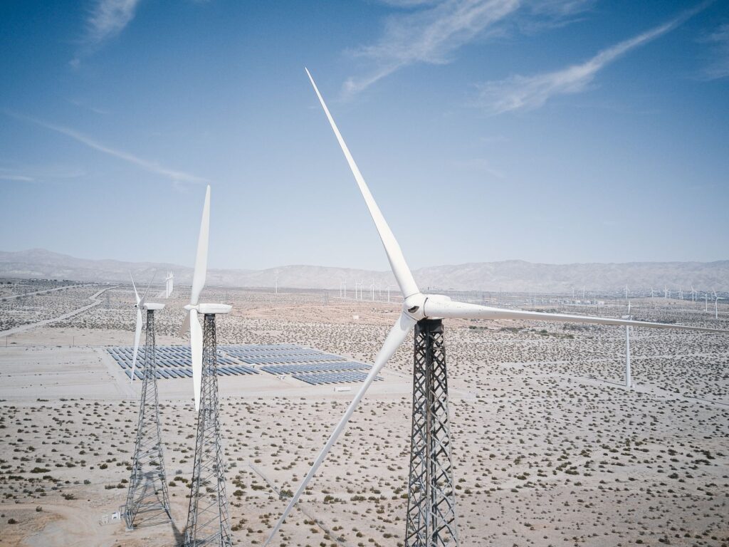 An aerial view of Nevada's renewable energy farms showcasing solar panels and wind turbines. — nevada energy future