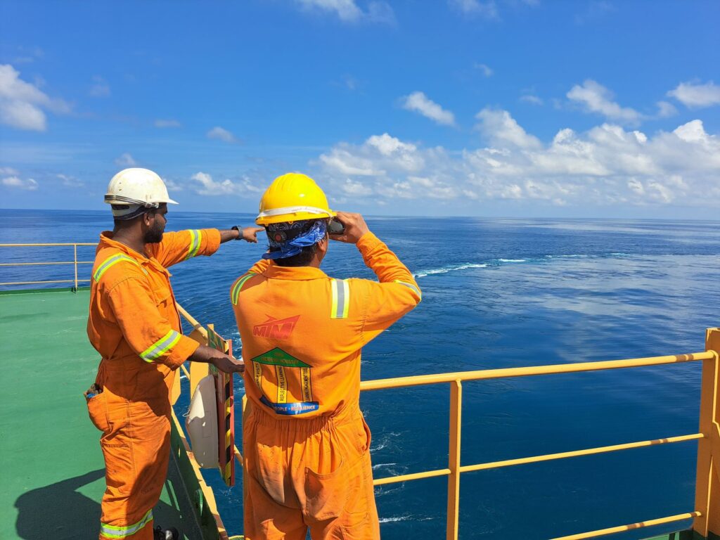 A photo of a diverse group of professionals working in an oil rig environment. — oil and gas careers