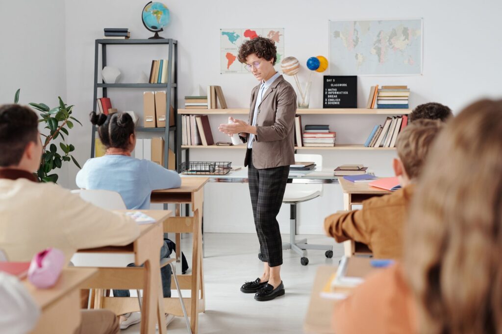 A teacher engaging with students in a modern classroom setup. — Paul For Nevada education reform