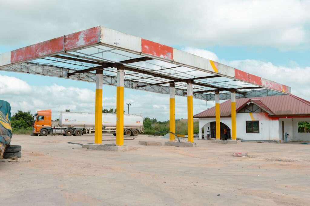 An image depicting a fuel distribution network with trucks and gas stations — oil and gas supply chain