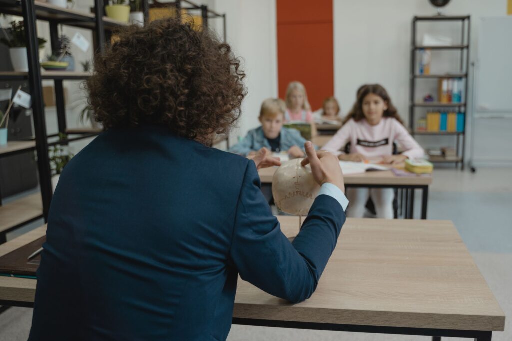 Illustration of a classroom with engaged students and a well-trained teacher. — Paul For Nevada education reform
