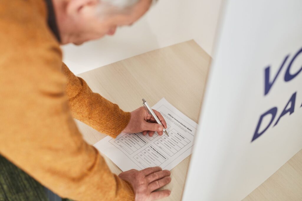 Image of a voter casting a ballot with a focus on candidate comparison. — Paul For Nevada compared to other candidates