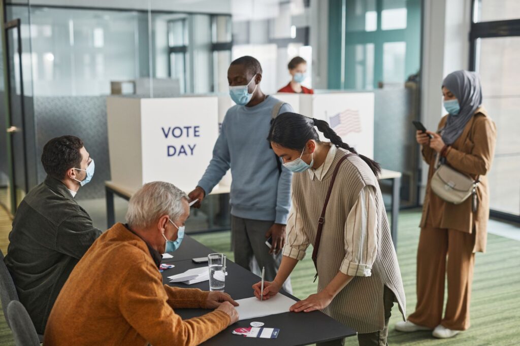 A group of diverse individuals filling out voter registration forms. — voter registration Nevada 2026
