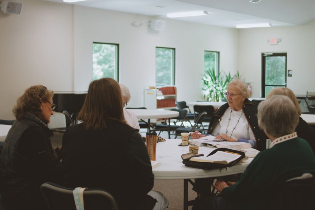 A photo of community members engaging in a local education reform meeting, showing support for Paul For Nevada education reform.