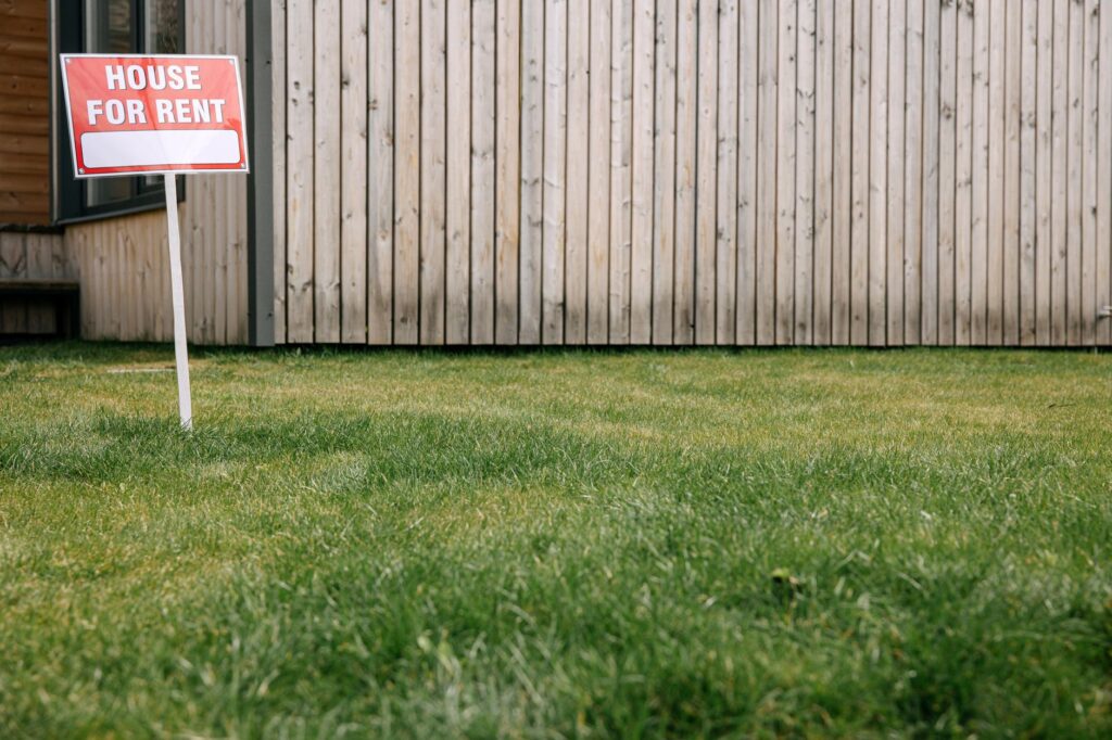 A close-up of a ‘For Rent’ sign in front of a modest apartment complex. — Paul For Nevada affordable housing